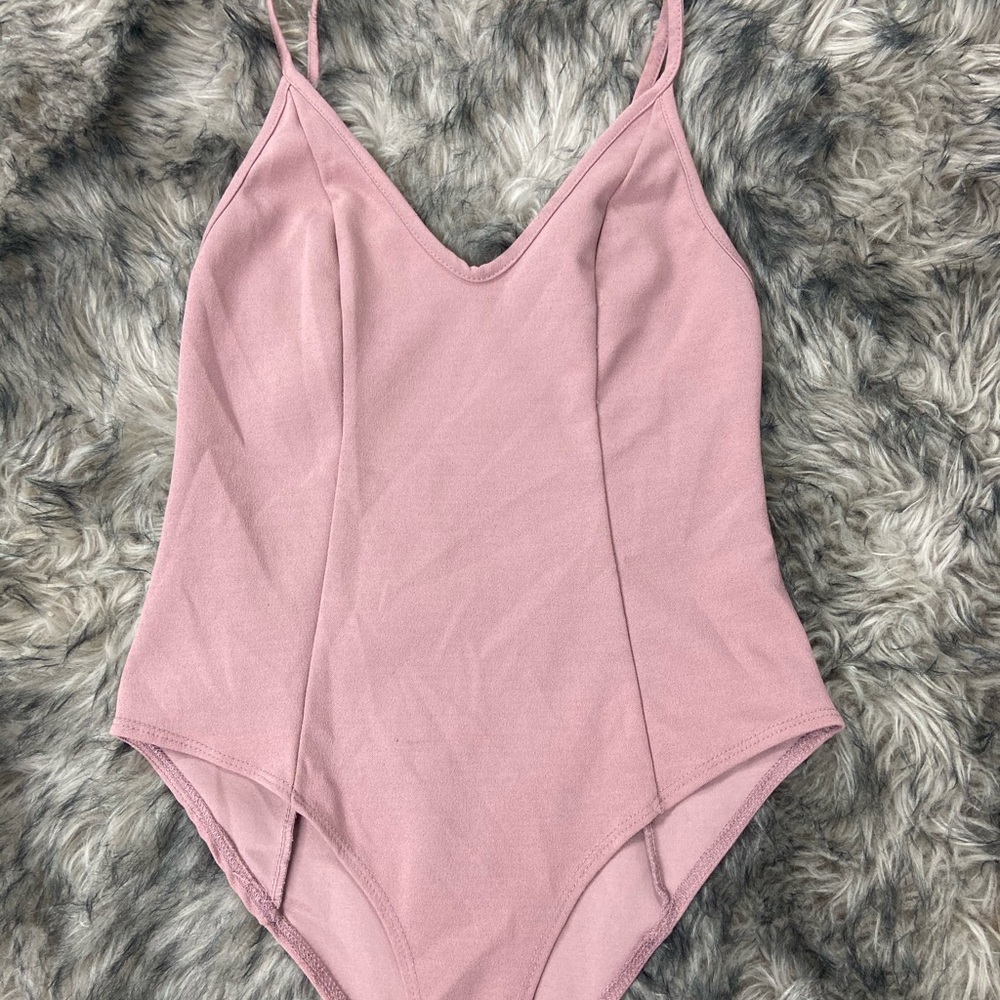 light pink body suit .